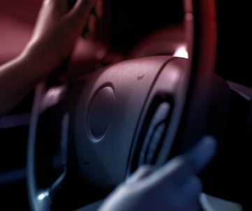 Steering wheel lit by red and blue light