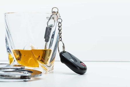 keys, handcuffs and a whisky glass