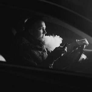 man smoking in car